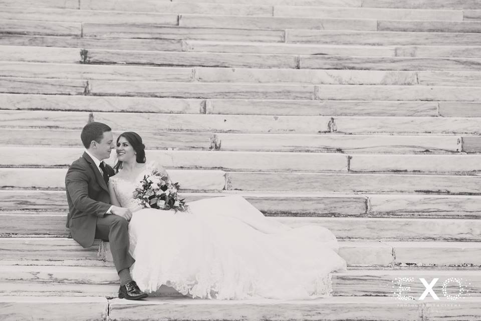 bride and groom sitting on steps outside Bourne Mansion