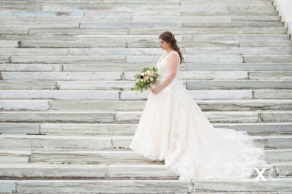bride on steps outside Bourne Mansion