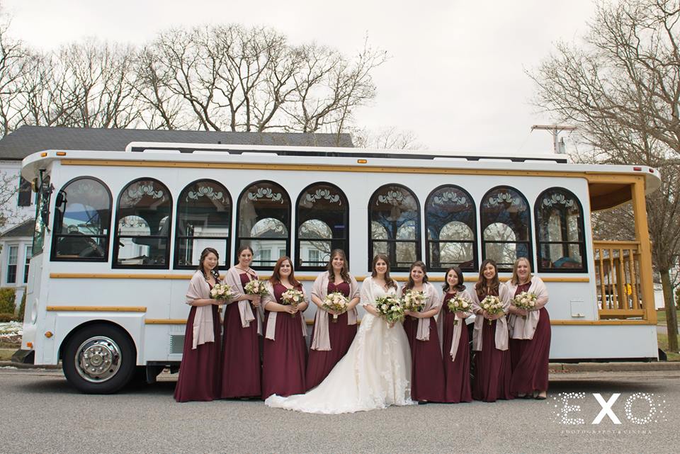 bride and bridesmaids in front of trolley