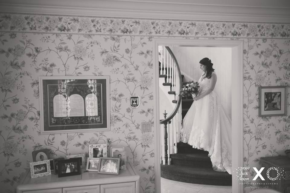bride all dressed in the stairs of her home
