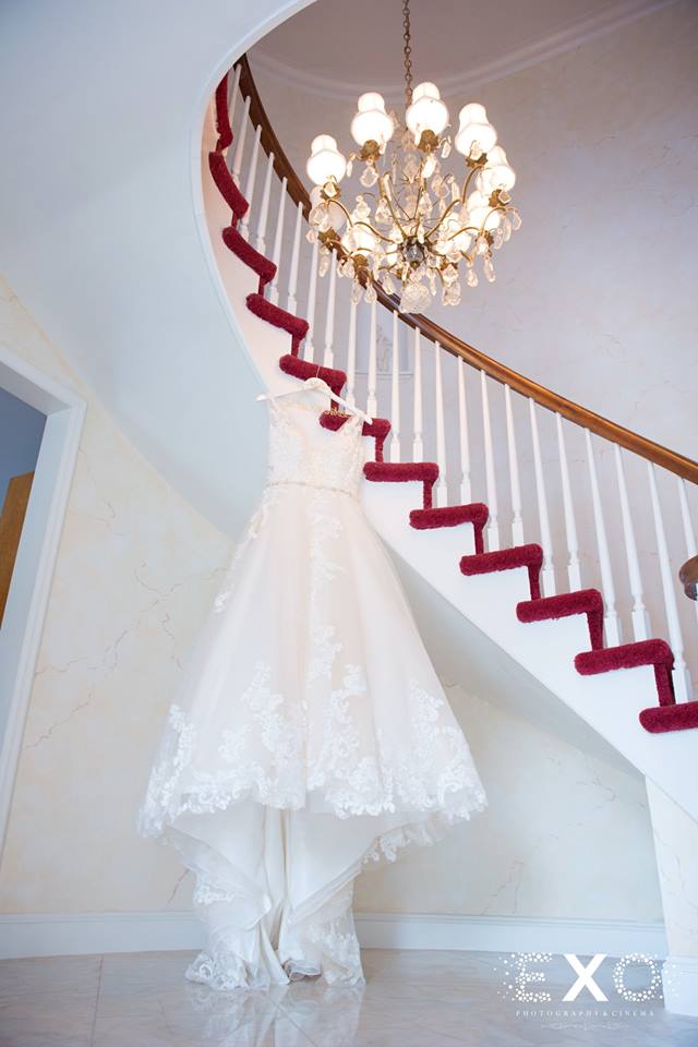 bride's dress hanging from stairs
