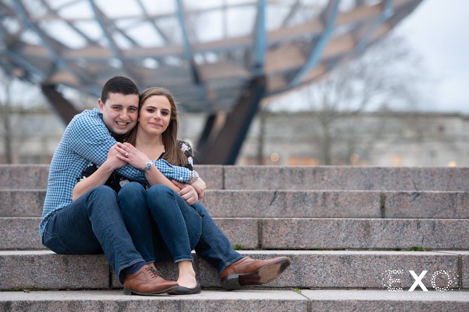 couple sitting on steps at Flushing Meadow Park