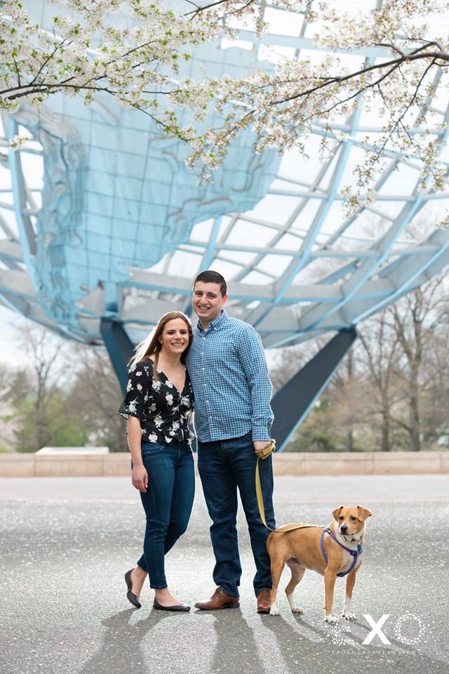 couple smiling with their dog