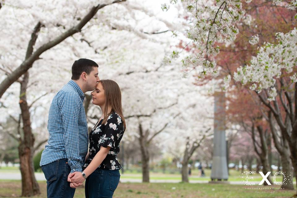couple kissing by the trees in Flushing Meadow Park