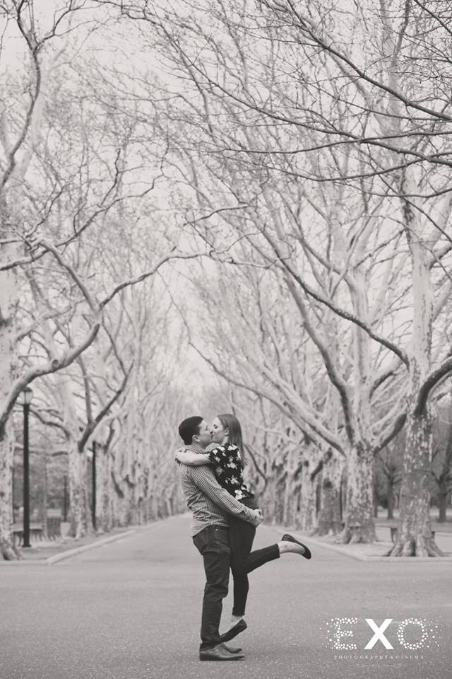 couple kissing among the trees in Flushing Meadow Park