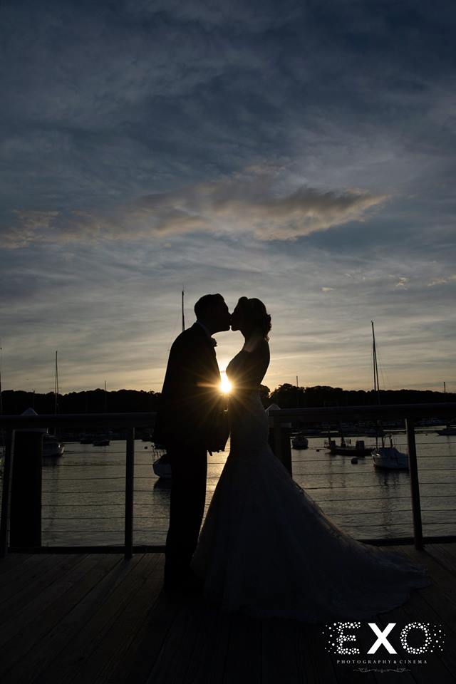 bride and groom kissing on balcony at Harbor Club at Prime