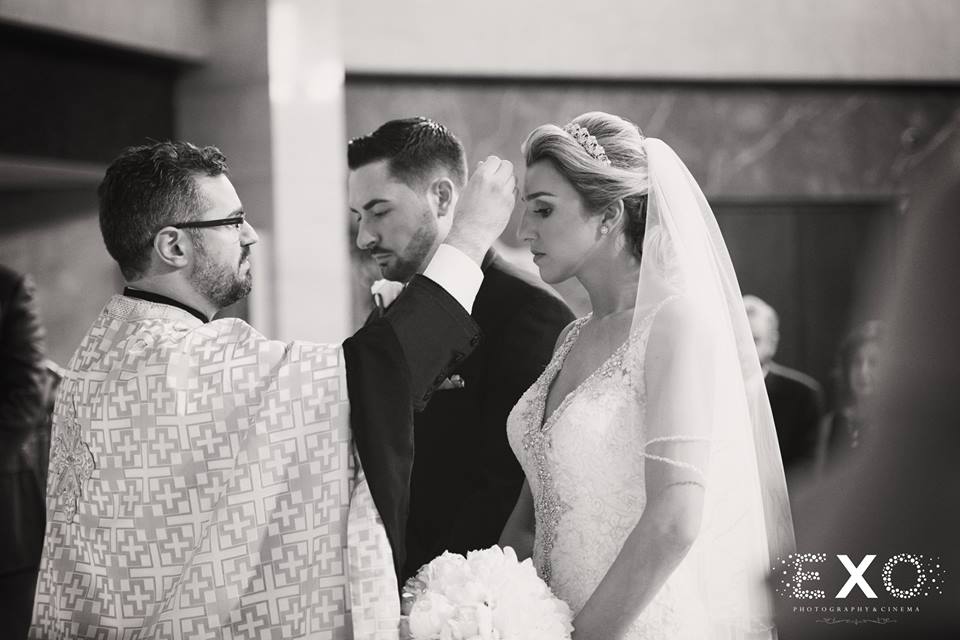 bride and groom during ceremony in black and white