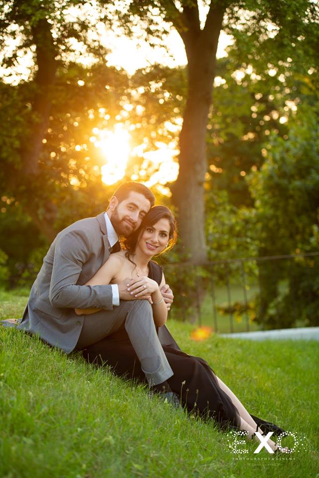 couple sitting on lawn at sunset