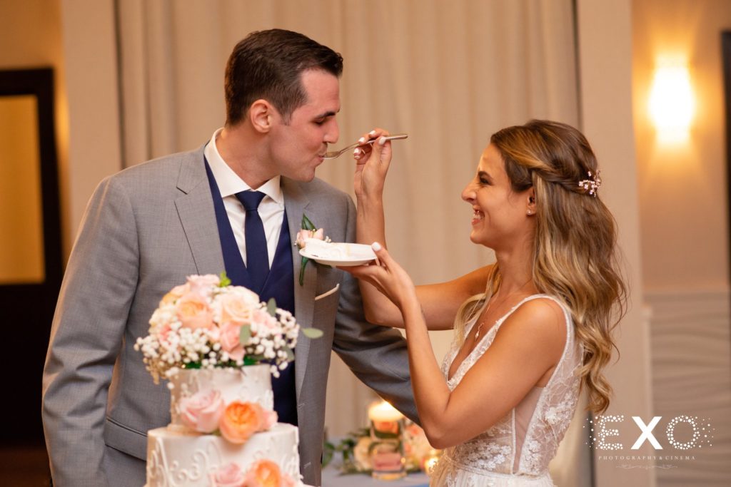 bride feeding groom cake