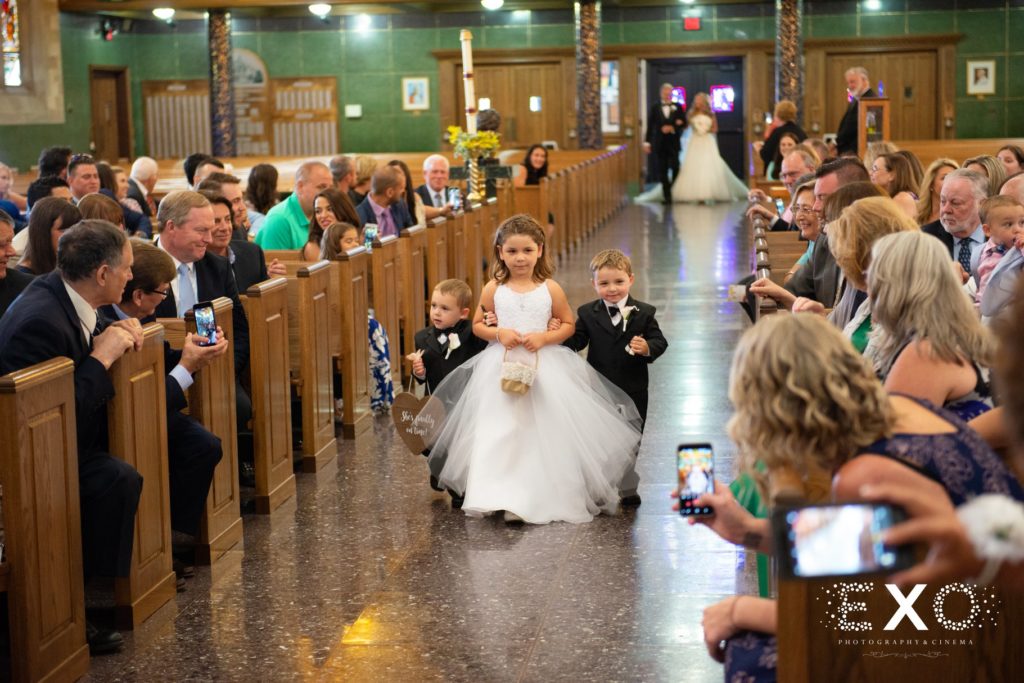 flower girl and ring bearers walking down the aisle