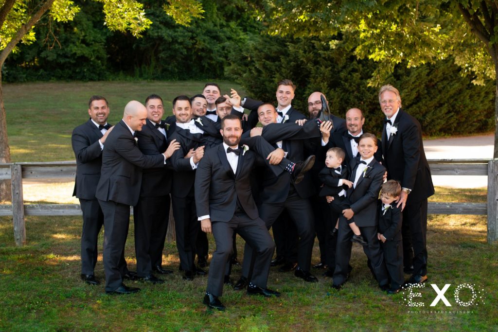 groomsmen holding groom