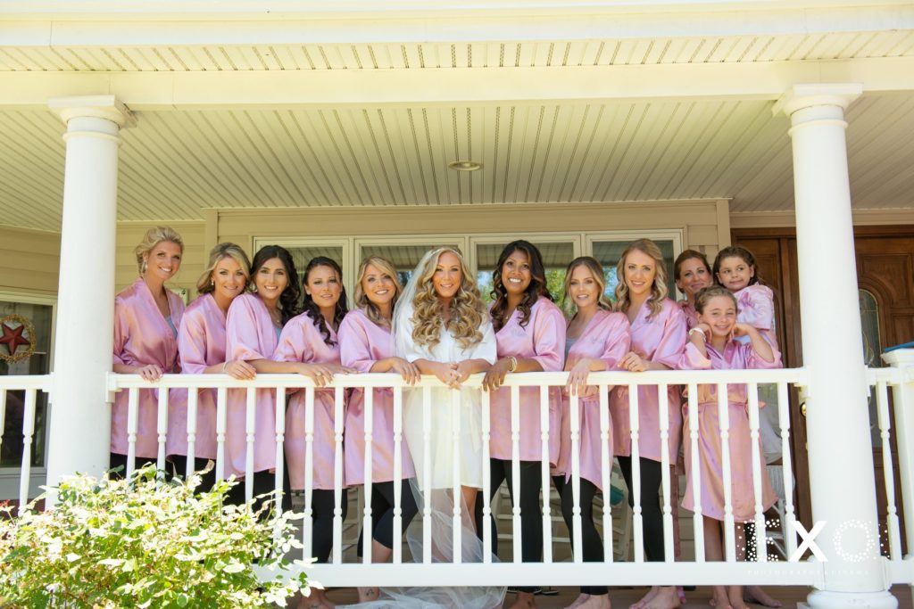 bride and bridesmaids on porch in robes