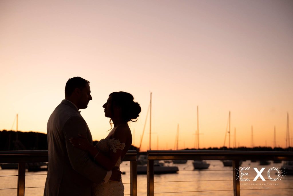 bride and groom on dock at sunset at Harbor Club at Prime