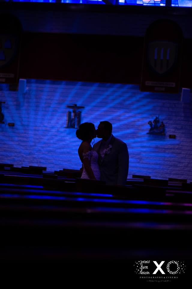 bride and groom kissing in the dark