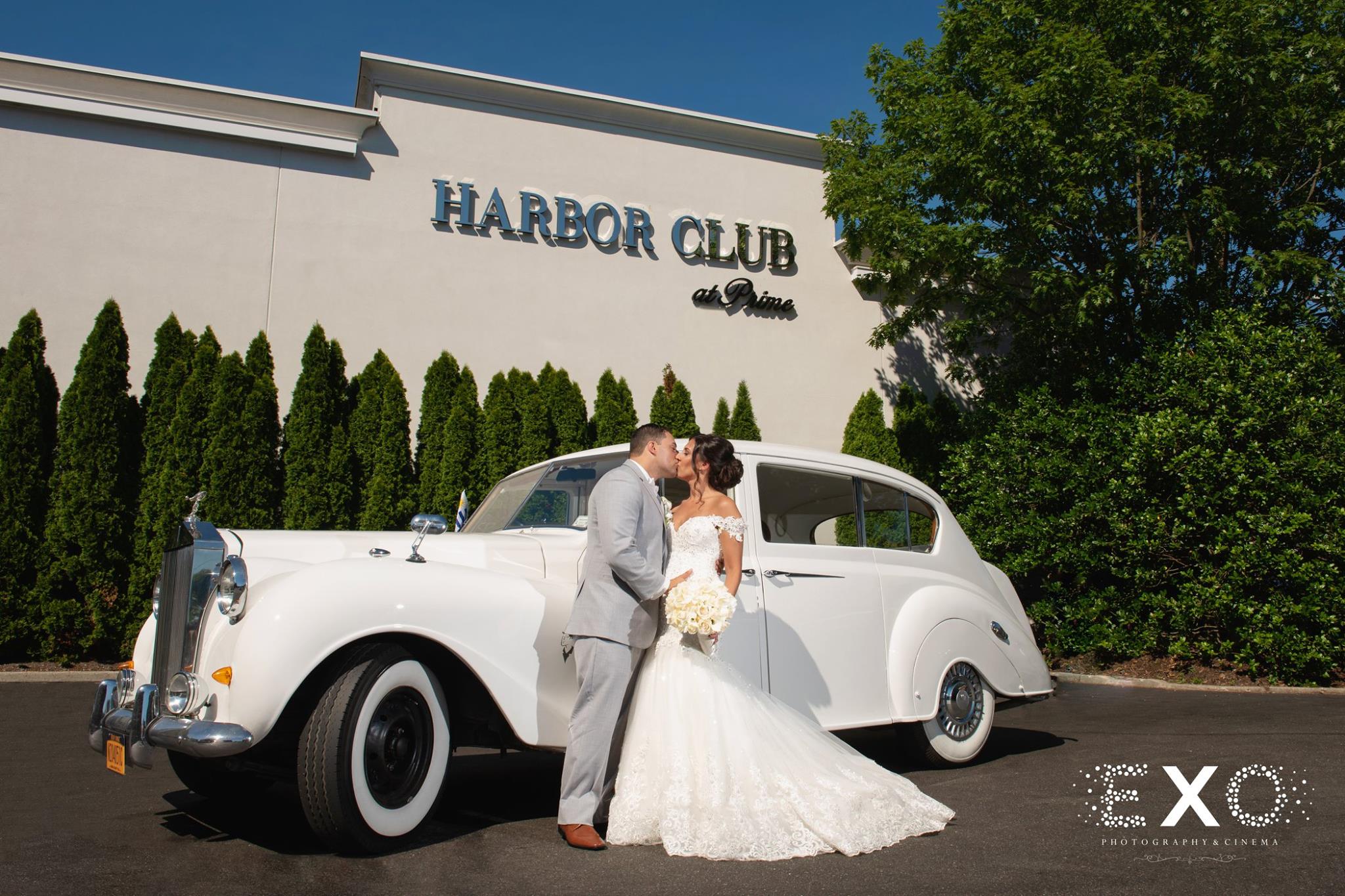 bride and groom kissing outside Harbor Club at Prime