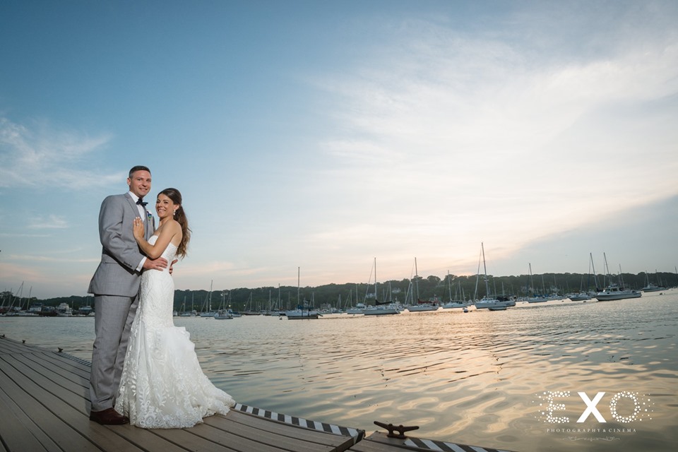 bride and groom standing by the water at Harbor Club at Prime