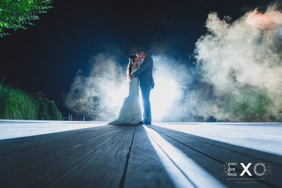 bride and groom kissing on dock at night at Harbor Club at Prime