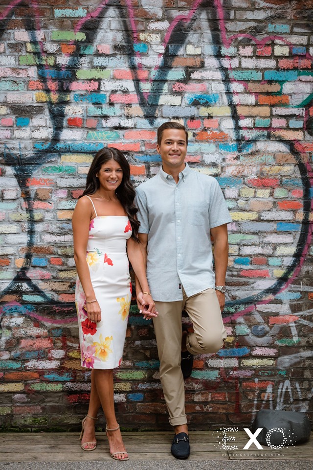 couple holding hands in front of graffiti wall in Downtown Manhattan
