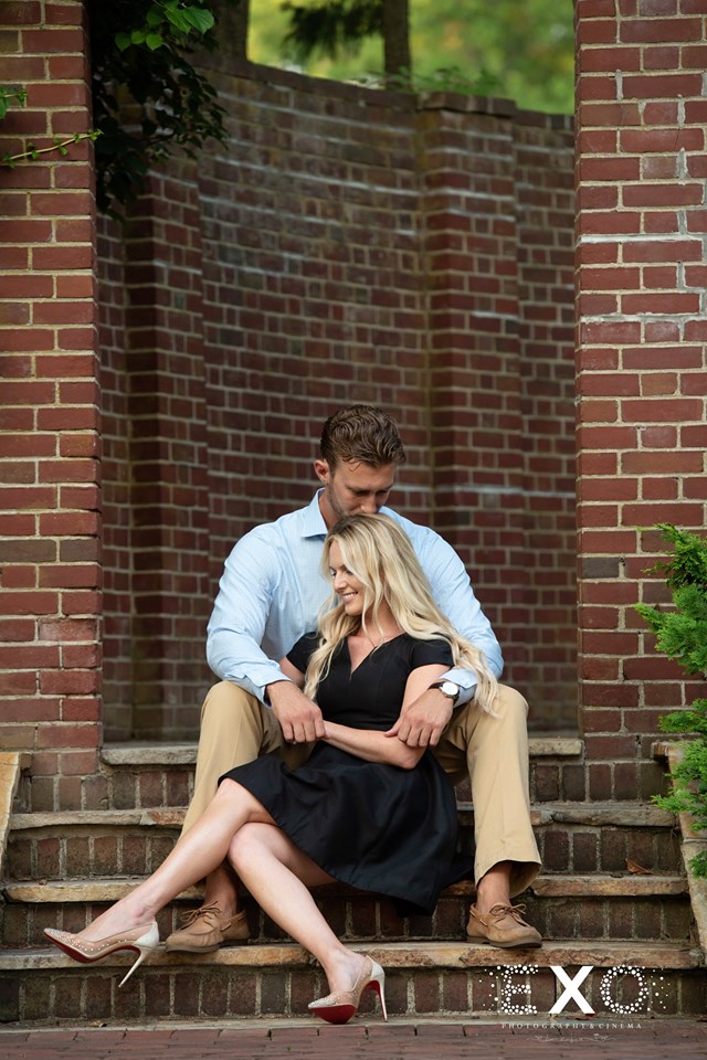 couple sitting on the steps at Woodside Club