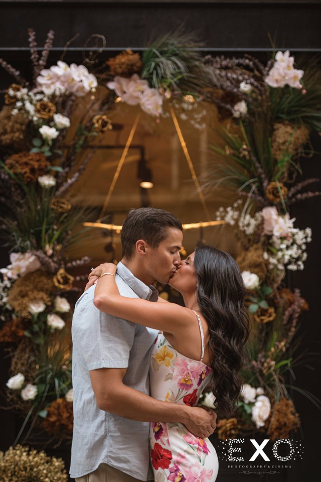 couple kissing in front of flower shop in Downtown Manhattan