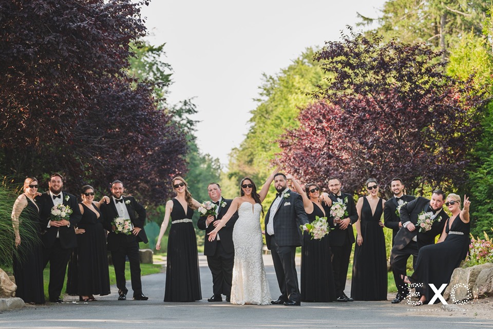 bride and groom with bridal party outside of The Mansion at Oyster Bay