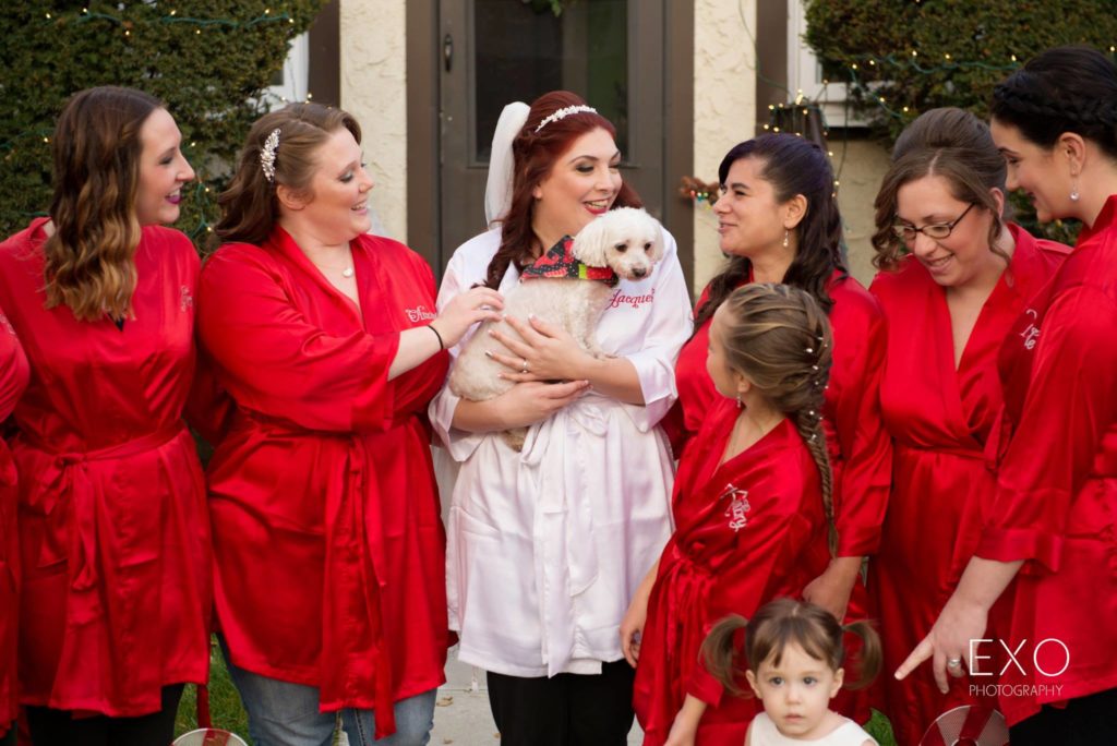 bride with her bridesmaids and dog outside her home
