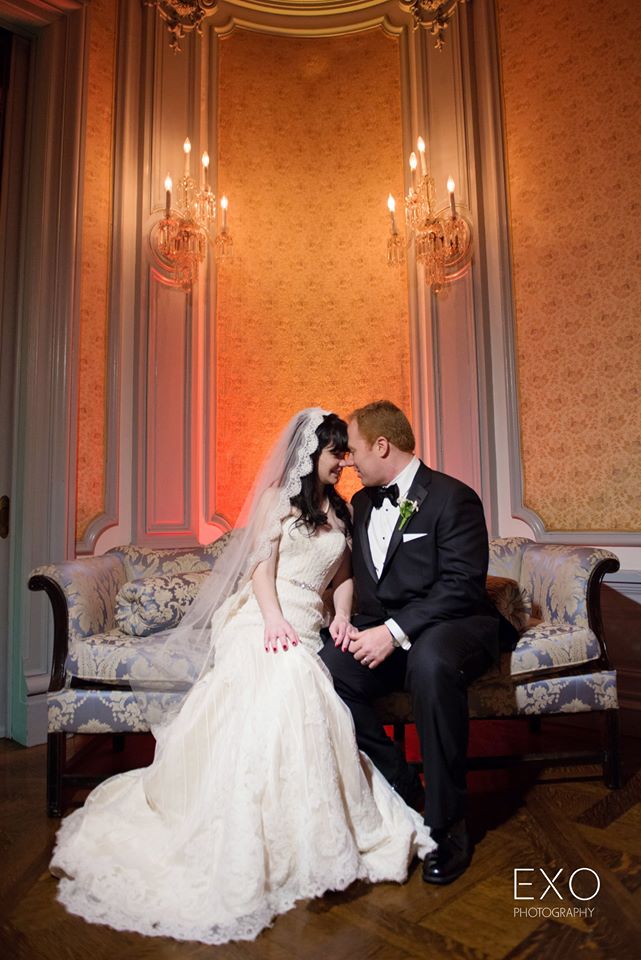 bride and groom sitting on the couch at Bourne Mansion