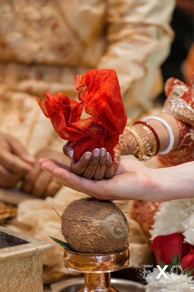 bride and groom's hands during traditional ceremony at Huntington Hilton