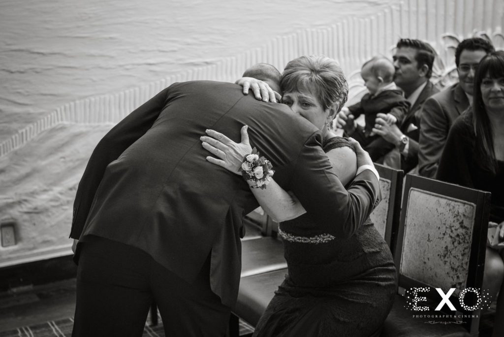 groom hugging his mom during ceremony at Insignia Steakhouse
