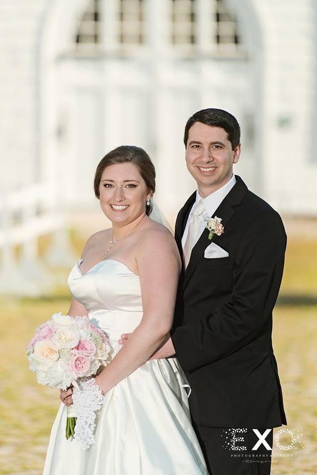 bride and groom smiling outside