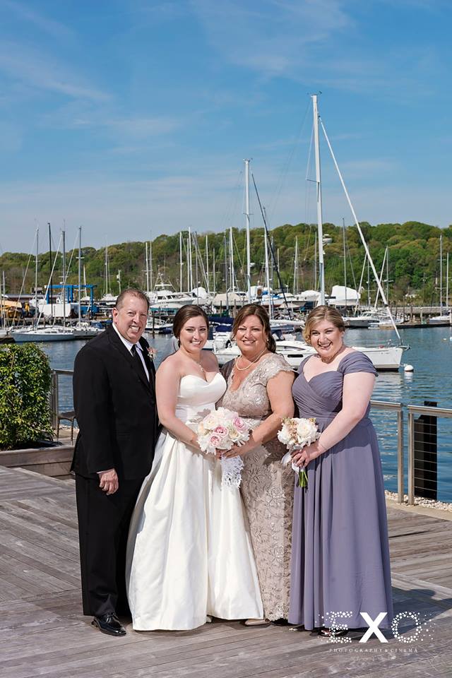 bride with family outside Harbor Club at Prime