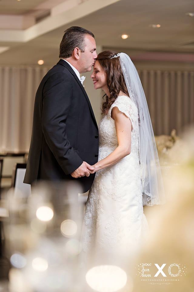 bride and groom kissing in the ballroom of Harbor Club at Prime