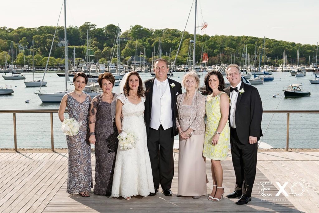 bride and groom with family outside Harbor Club at Prime
