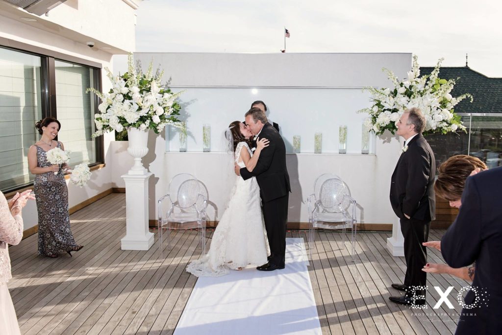 bride and groom kissing as husband and wife at Harbor Club at Prime