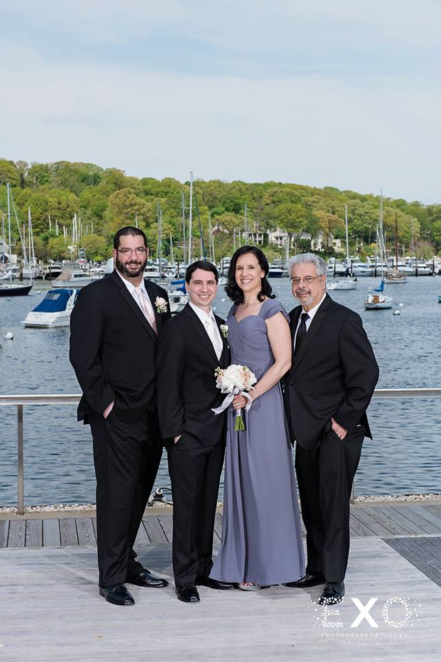 groom and family on the dock outside Harbor Club at Prime