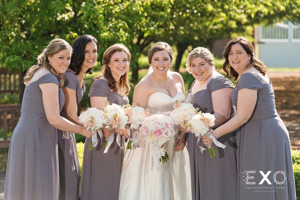 bride and bridesmaids with their bouquets outside Harbor Club at Prime