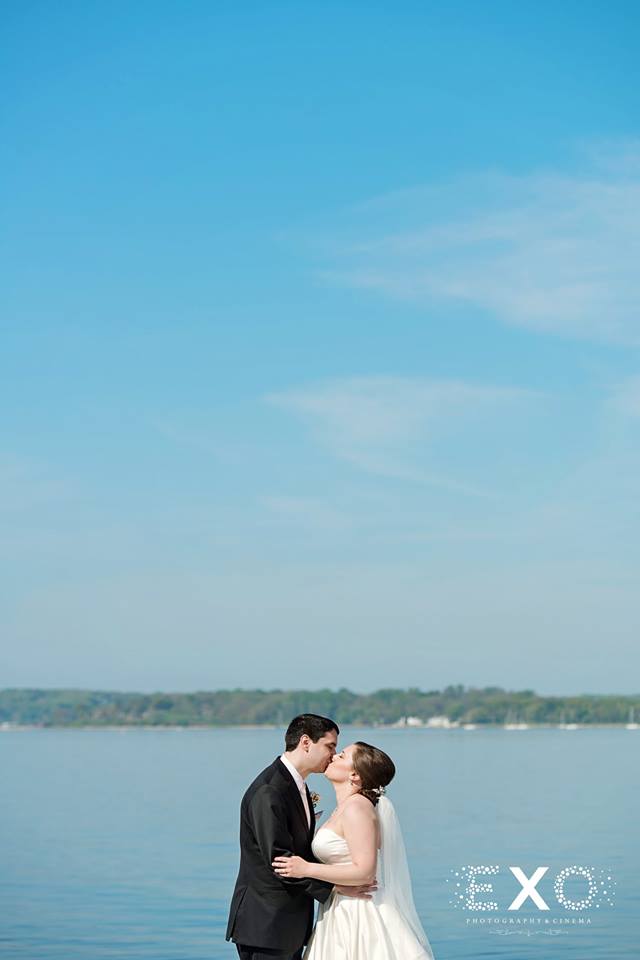 bride and groom kissing by the water at Harbor Club at Prime