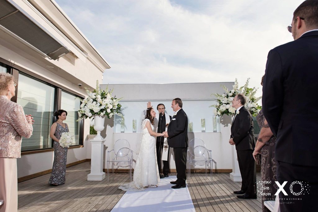 bride and groom exchanging vows at Harbor Club at Prime