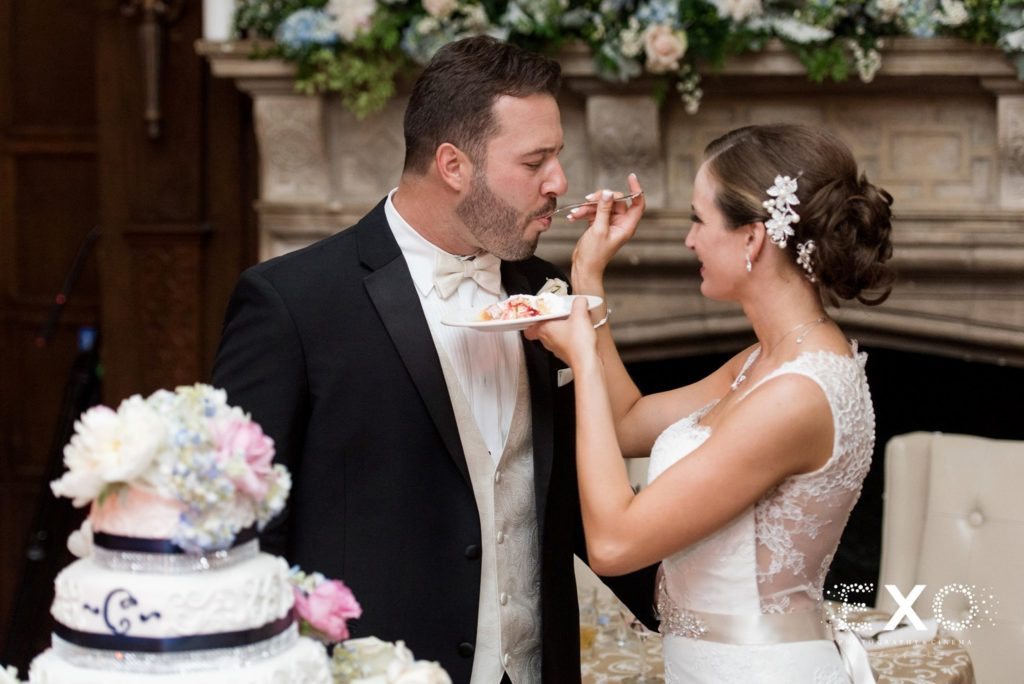 bride feeding groom cake at NYIT de Seversky Mansion