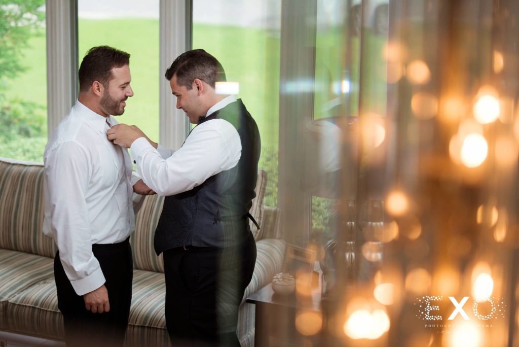 groom getting help with his tie