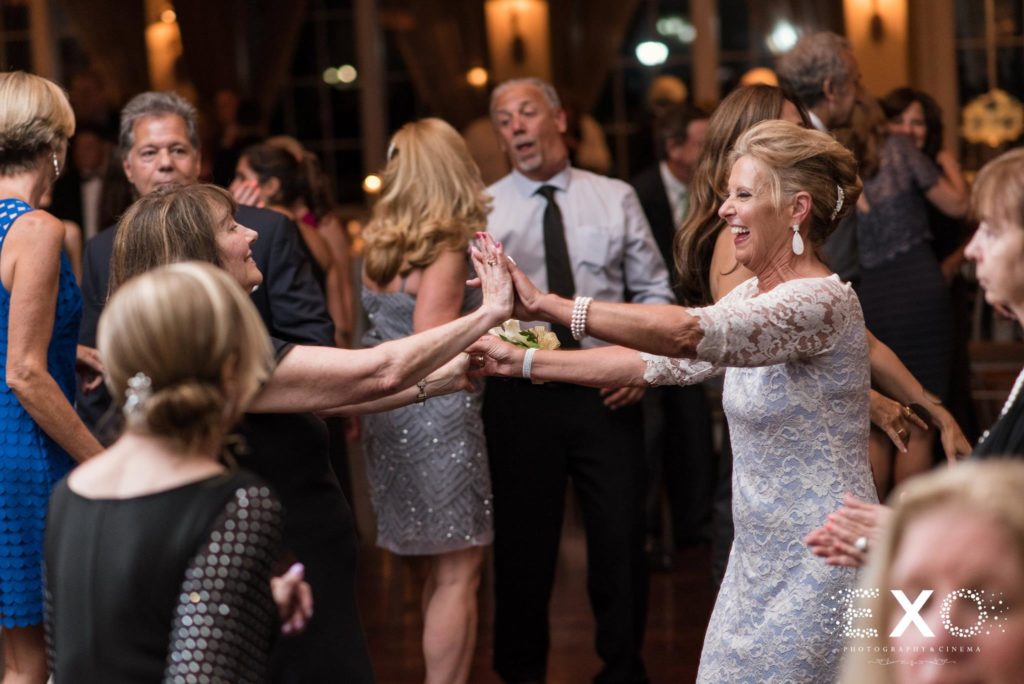 bride and groom's mothers dancing together at Carlyle on the Green
