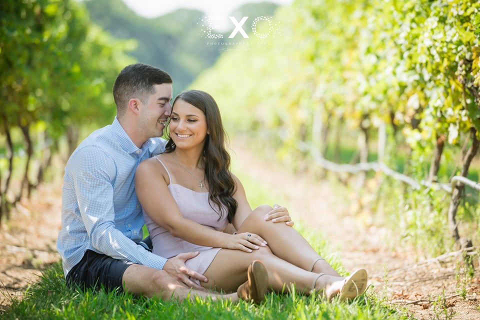 couple sitting within the vineyards at Pugliese Vineyards
