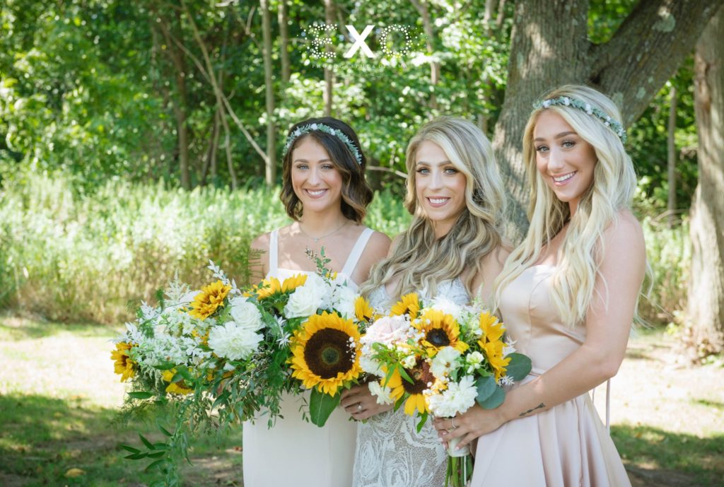 bride and bridesmaids posing with their bouquets