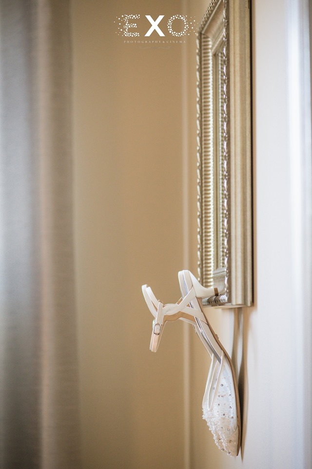 bride's shoes hanging on the mirror of The Loft by Bridgeview