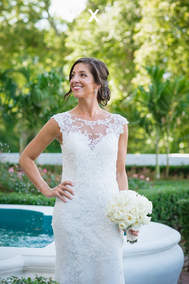 beautiful bride standing by the fountain outside Harbor Club at Prime
