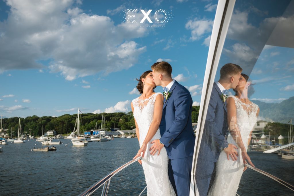 bride and groom kissing on yacht