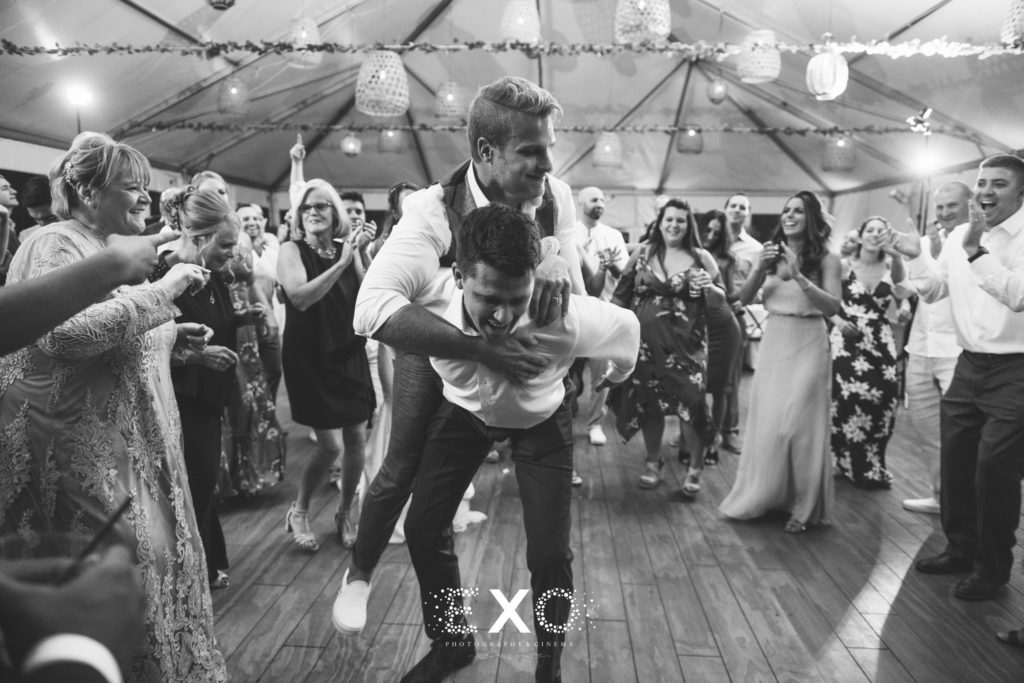 groom and friend dancing during reception at Gurney's Montauk Resort