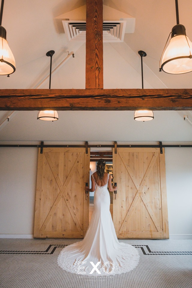 bride walking through wooden doors at Gurney's Montauk Resort