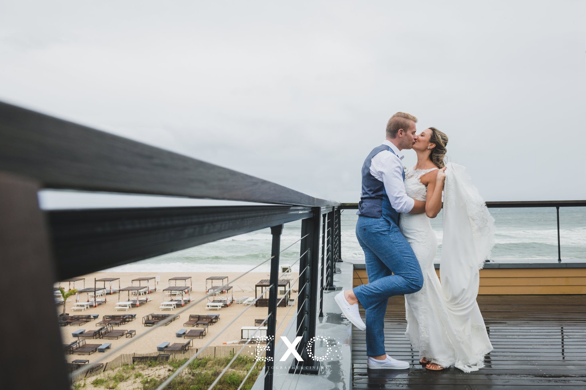 bride and groom kissing on balcony at Gurney's Montauk Resort