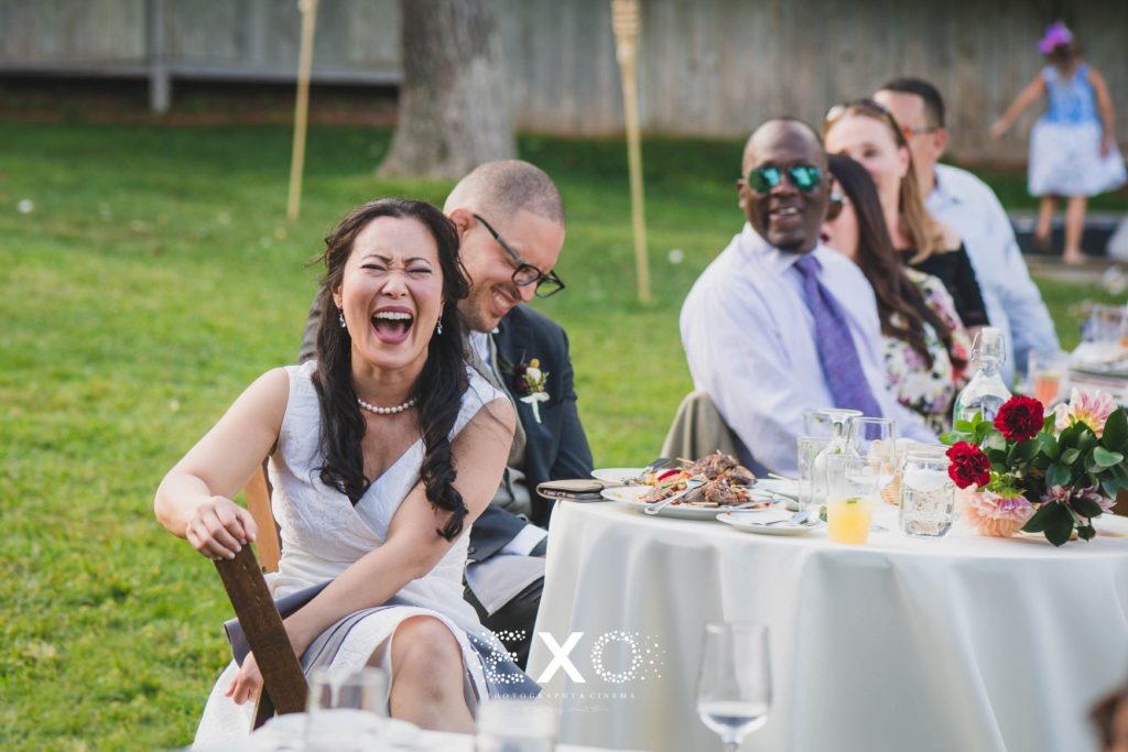 bride and groom laughing during speeches